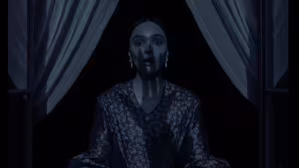 Ellen Hutter (Lily-Rose Depp) standing wide-eyed between dark curtains