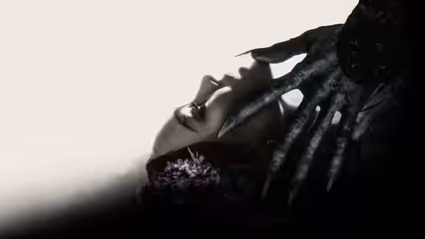 A pale woman reclining near a monstrous clawed hand