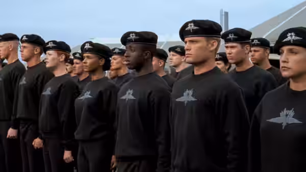 Recruits in black uniforms standing in formation wearing berets