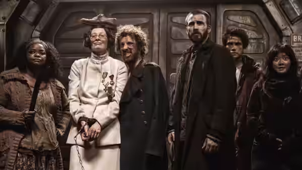 Mason (Tilda Swinton) and chained captives line up in a corridor