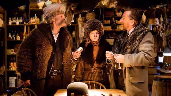 John Ruth, Daisy Domergue and Oswaldo Mobray examine a small item inside a cluttered shop