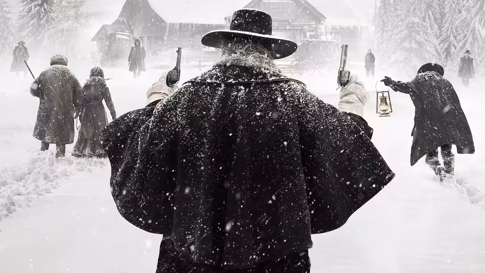 Armed figures in heavy coats walk through falling snow toward wooden buildings