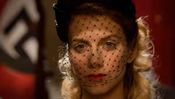 Bridget von Hammersmark in a veiled hat looking forward