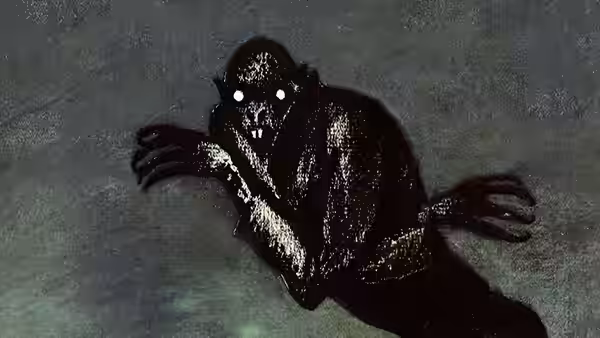 Count Orlok (Max Schreck) raises his clawed hands in the darkness