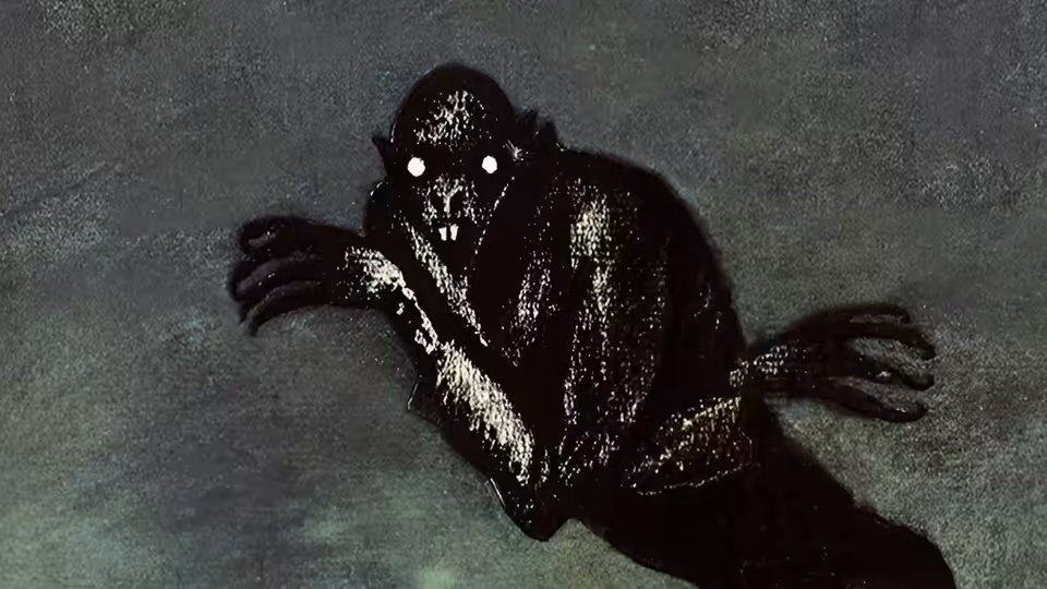 Count Orlok (Max Schreck) raises his clawed hands in the darkness