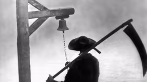 A silhouetted figure stands beneath a hanging bell beside a large curved blade