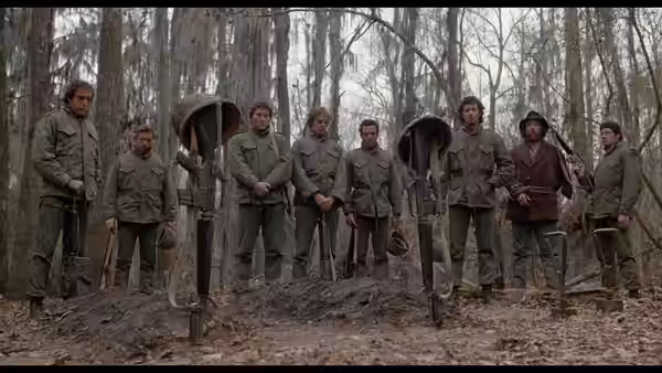Soldiers stand in a line holding rifles in a forest