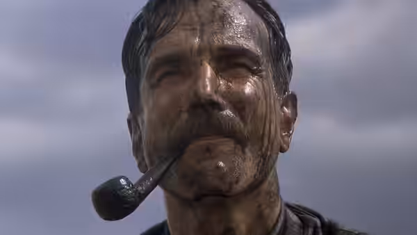 Daniel Plainview (Daniel Day-Lewis) with pipe in mouth and dirt on face