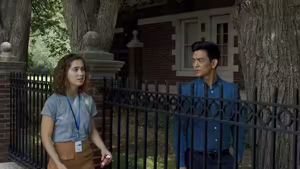 Casey (Haley Lu Richardson) and Jin (John Cho) talking by a brick building
