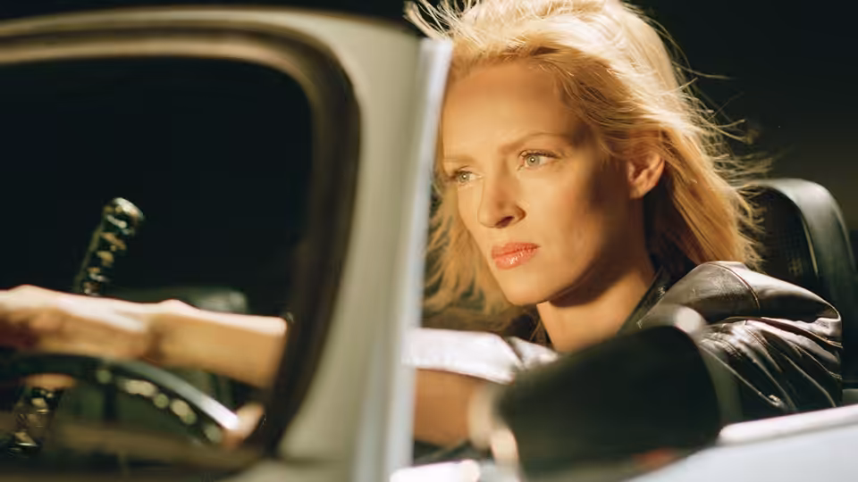 Beatrix Kiddo (Uma Thurman) in the driver's seat of a car