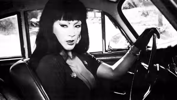 Varla (Tura Satana) grips the steering wheel inside a car
