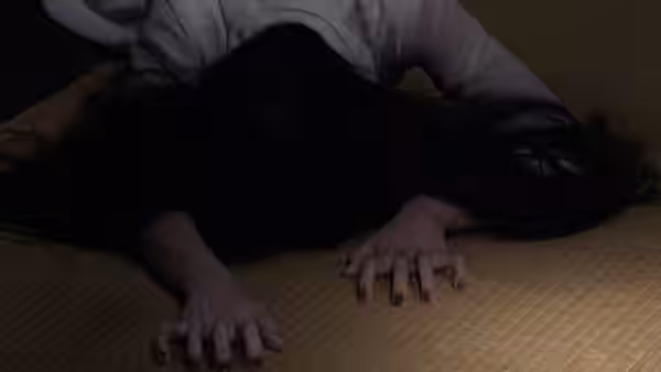 Woman with long dark hair lying face down on a tatami mat