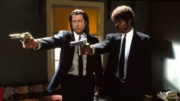 Vincent Vega (John Travolta) and Jules Winnfield (Samuel L. Jackson) aiming handguns