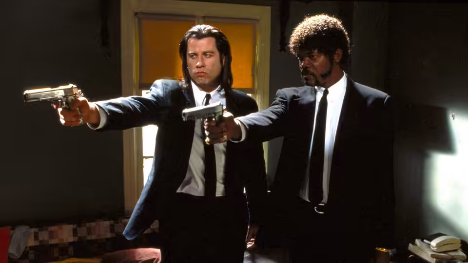Vincent Vega (John Travolta) and Jules Winnfield (Samuel L. Jackson) aiming handguns