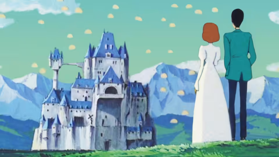 A man in green and a woman in white stand before a mountain castle