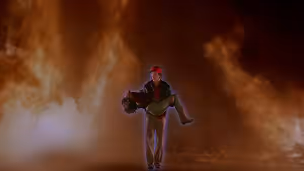 A man carries an unconscious woman through swirling smoke
