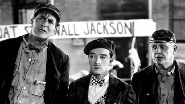 Steamboat Bill Sr. (Ernest Torrence), Steamboat Bill Jr. (Buster Keaton), and John King (Tom McGuire) stand together
