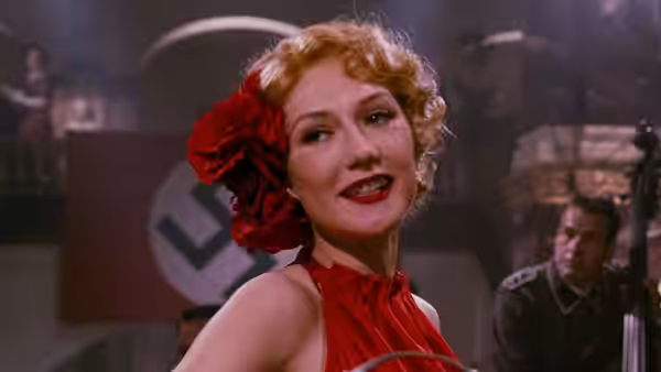 Ellis (Carice van Houten) sings onstage as a German officer watches
