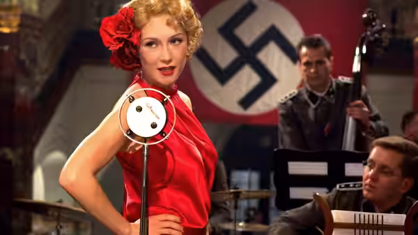 Ellis (Carice van Houten) sings before a band beneath a Nazi banner