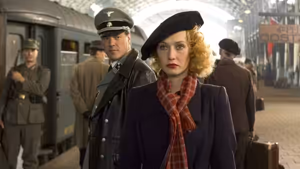 Rachel (Carice van Houten) stands at a railway station beside a German officer