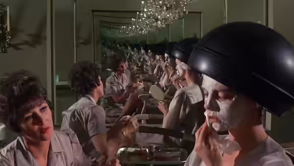 Men in pale shirts and dark helmets sit facing one another in mirrored rows