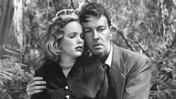 Annie Laurie Starr (Peggy Cummins) leans close to Bart Tare (John Dall) among the trees