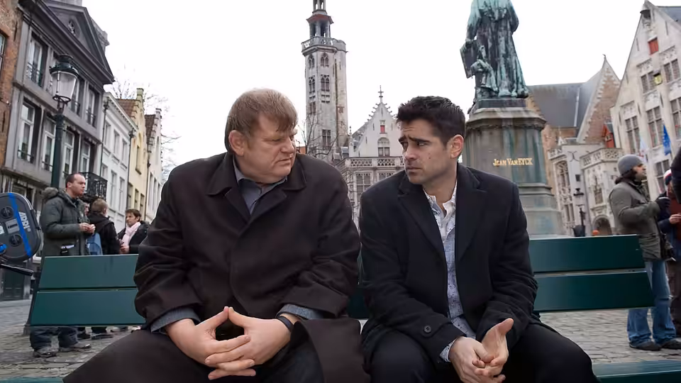 Ken (Brendan Gleeson) and Ray (Colin Farrell) seated on a bench in a square