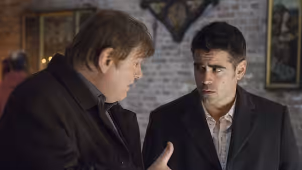 Ken (Brendan Gleeson) speaking to Ray (Colin Farrell) in a brick-walled room