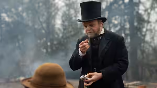 Chief Factor (Toby Jones) tastes a morsel in the woods