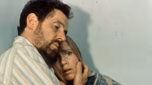 Johan (Erland Josephson) holds Marianne (Liv Ullmann) close against a wall