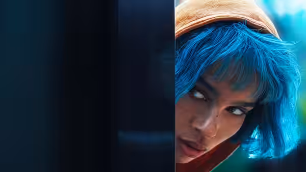 Angela Childs (Zoë Kravitz) peering cautiously from behind a door