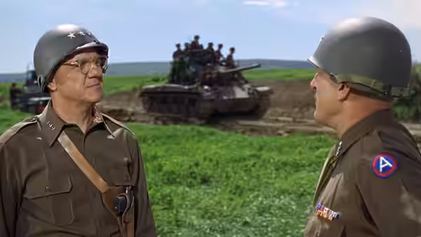 General Patton speaking with an officer before tanks in a field