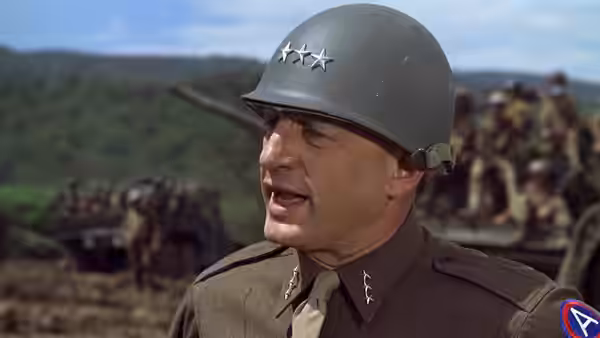 General Patton addressing troops from a battlefield position