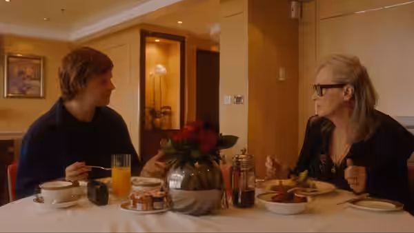 Tyler Hughes (Lucas Hedges) and Alice Hughes (Meryl Streep) at breakfast