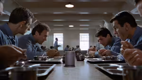 Prisoners eat at long tables in the prison dining hall