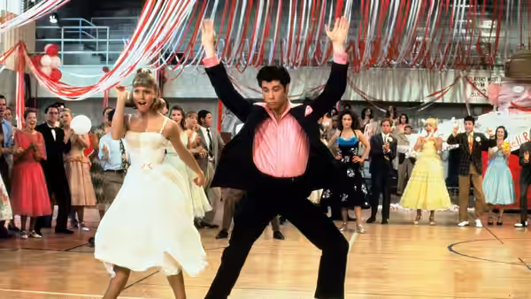 Sandy (Olivia Newton-John) and Danny (John Travolta) dance in the gymnasium