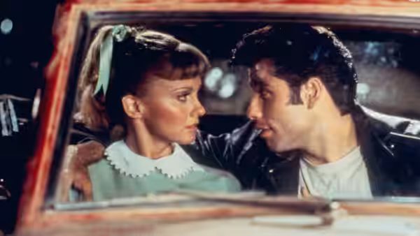 Sandy (Olivia Newton-John) faces Danny (John Travolta) inside a parked car