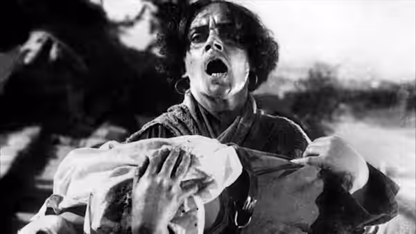 A woman cries out while cradling a wounded sailor in her arms