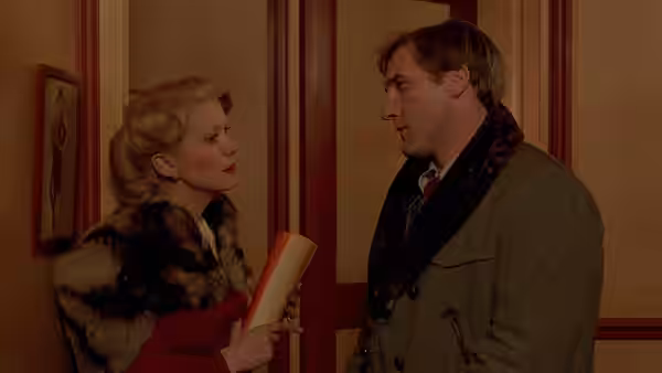 Marion Steiner (Catherine Deneuve) speaks with Bernard Granger (Gérard Depardieu) in a hallway