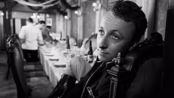 Maciek Chełmicki (Zbigniew Cybulski) reclines in a chair inside the hotel