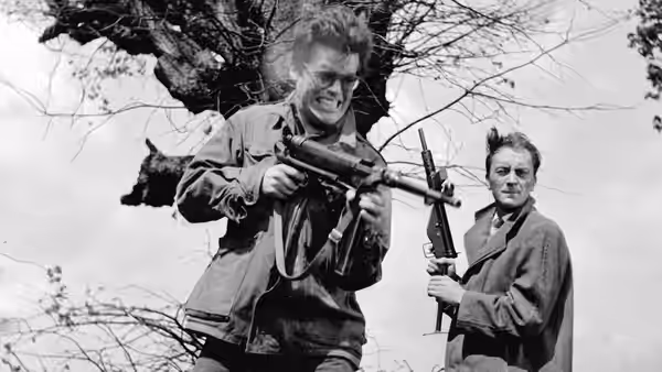 Maciek Chełmicki (Zbigniew Cybulski) grips a submachine gun beside an armed man