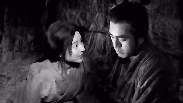 A young woman and young man facing each other closely indoors