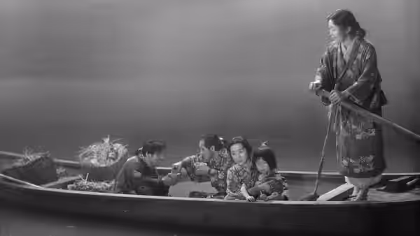 A woman stands in a boat while passengers sit together on the water