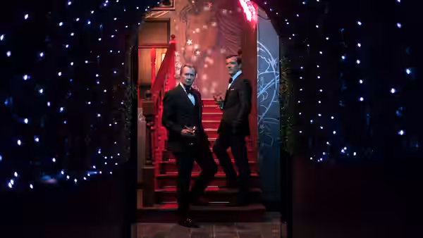 Jürgen Mossack (Gary Oldman) and Ramón Fonseca (Antonio Banderas) in a red-lit foyer