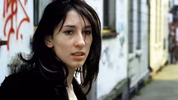 Sibel Güner (Sibel Kekilli) looks ahead on a graffiti-marked street