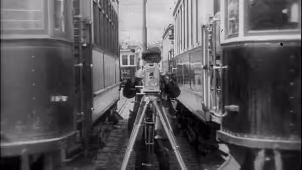The Cameraman (Mikhail Kaufman) operates his camera between two streetcars