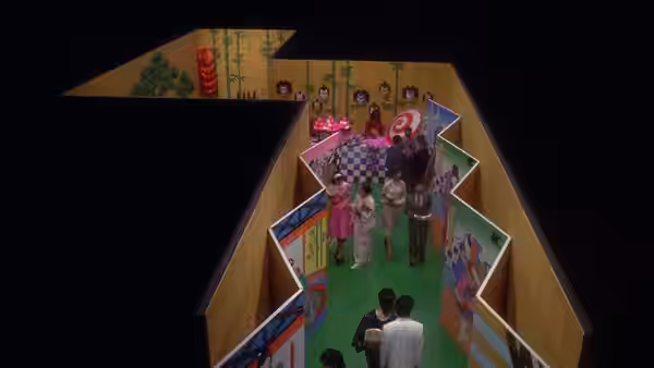 group of people stand inside a colorful open-walled room with patterned panels and green floor
