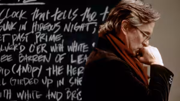Grady Tripp (Michael Douglas) seated in front of a chalkboard with writing