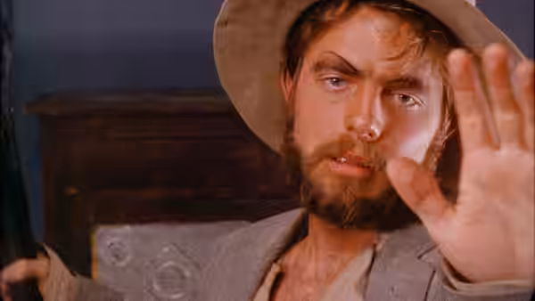 Torgo raises his hand while looking ahead intently
