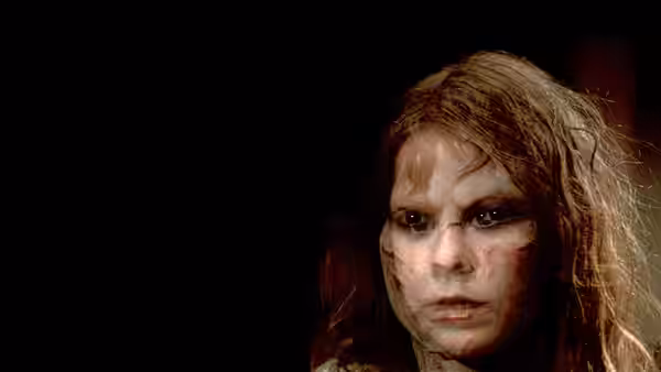 Close-up of Regan's (Linda Blair) possessed face covered in dirt and scratches